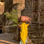 Lady carrying two cylinders