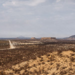 a gravel road cutting across the desert in Damaraland